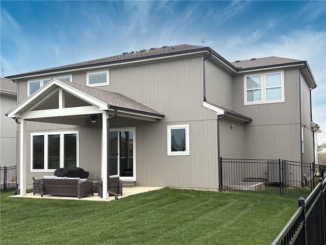 rear view of house with a fenced backyard, a patio, a lawn, and an outdoor hangout area