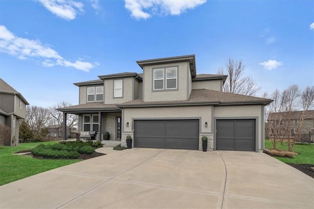 prairie-style home with a front lawn, an attached garage, covered porch, and stucco siding