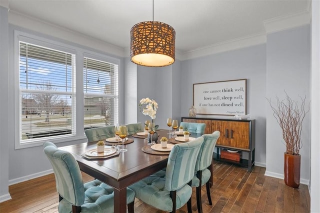 dining space with dark wood-style floors, baseboards, and ornamental molding