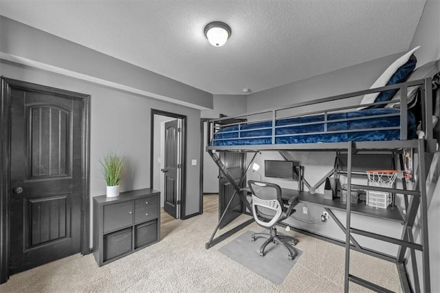 bedroom featuring a textured ceiling and carpet