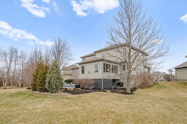 rear view of property featuring a yard