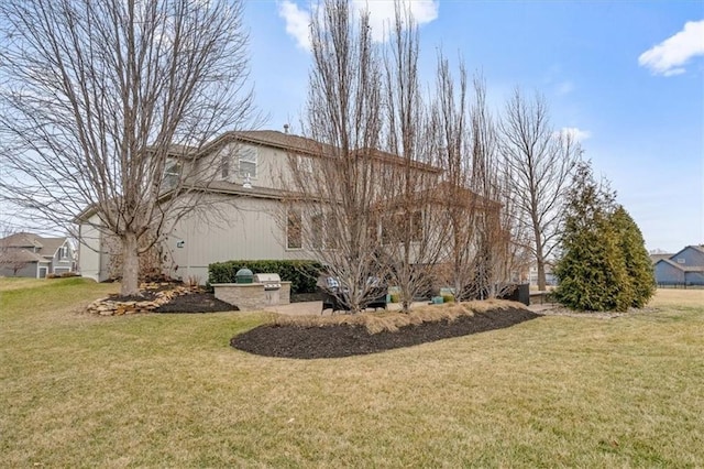 view of side of home with a lawn