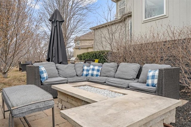 view of patio featuring an outdoor living space with a fire pit