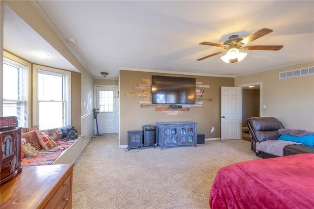 carpeted bedroom featuring baseboards, visible vents, and crown molding