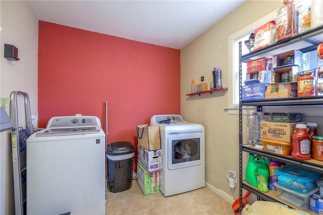 clothes washing area with laundry area, tile patterned flooring, baseboards, and independent washer and dryer