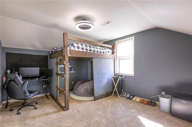 carpeted bedroom with vaulted ceiling, a textured ceiling, and baseboards