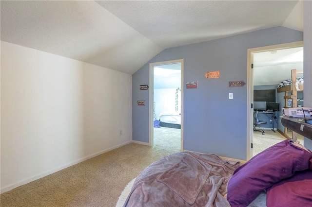 bedroom with lofted ceiling, a textured ceiling, carpet flooring, and baseboards