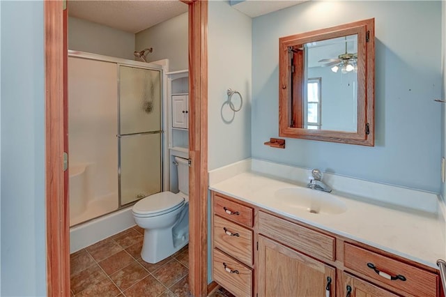 full bath featuring toilet, a stall shower, vanity, and tile patterned flooring