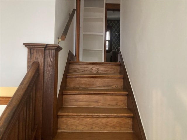 stairway featuring baseboards