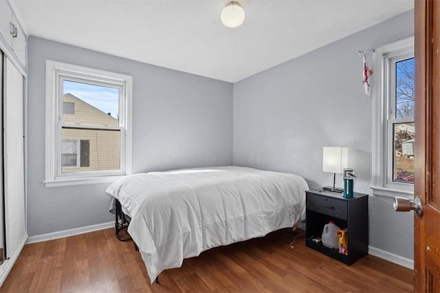 bedroom featuring baseboards and wood finished floors