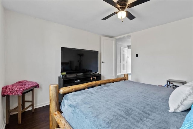 bedroom featuring ceiling fan, dark wood-style flooring, and baseboards