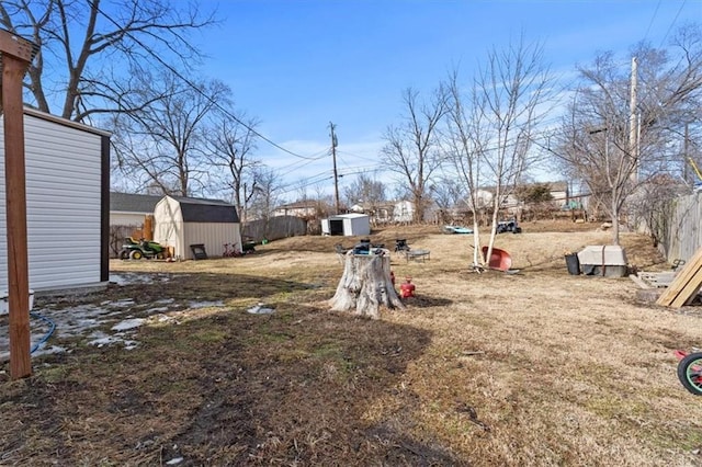 view of yard with an outbuilding and a shed