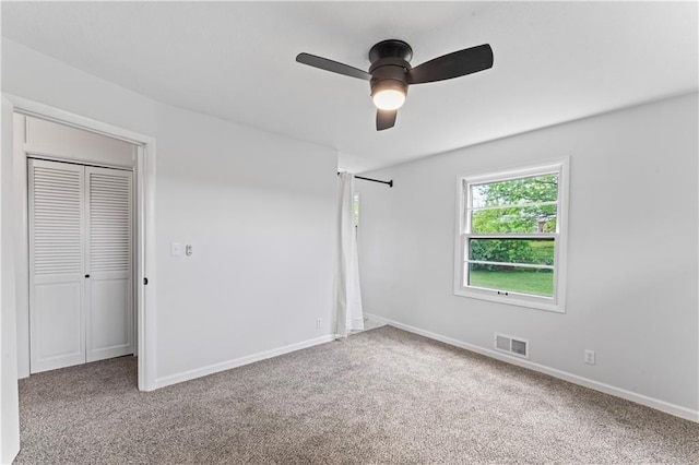 unfurnished bedroom with carpet flooring, baseboards, and a ceiling fan