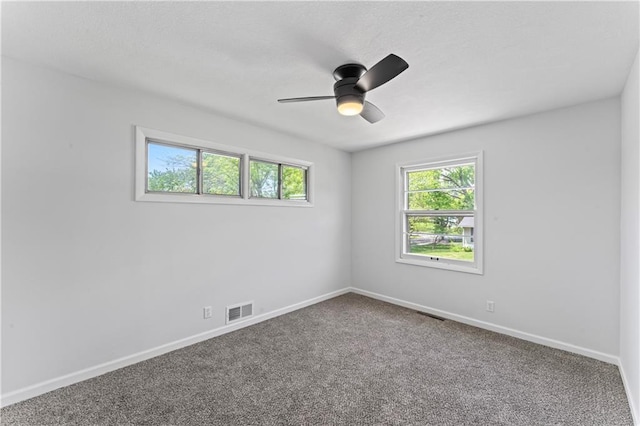 spare room featuring baseboards, carpet, and a ceiling fan