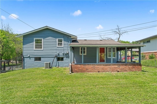rear view of property with central AC