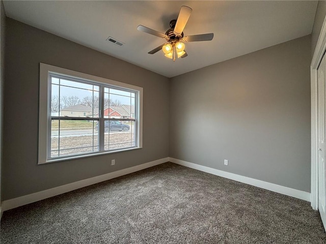 empty room with visible vents, ceiling fan, baseboards, and carpet floors