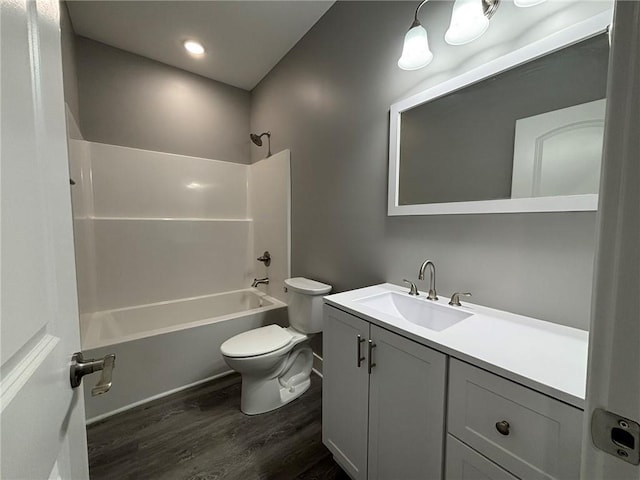 bathroom with tub / shower combination, toilet, vanity, and wood finished floors