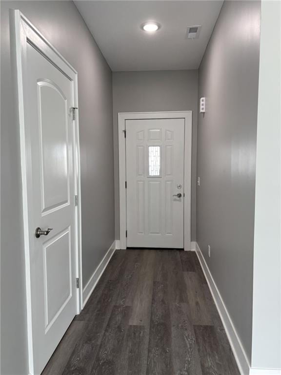 entryway with visible vents, baseboards, and dark wood-style flooring