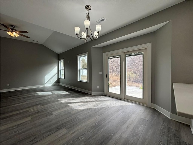 empty room featuring dark wood finished floors, visible vents, baseboards, and vaulted ceiling