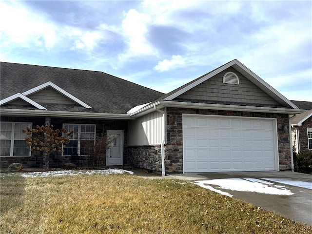 single story home featuring an attached garage, stone siding, driveway, and a front lawn