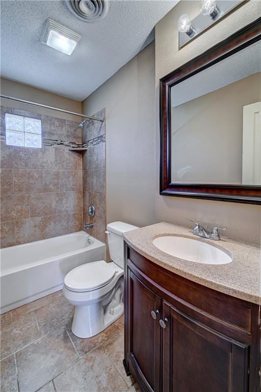 bathroom with bathtub / shower combination, a textured ceiling, toilet, and vanity