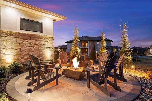 patio terrace at dusk with an outdoor fire pit