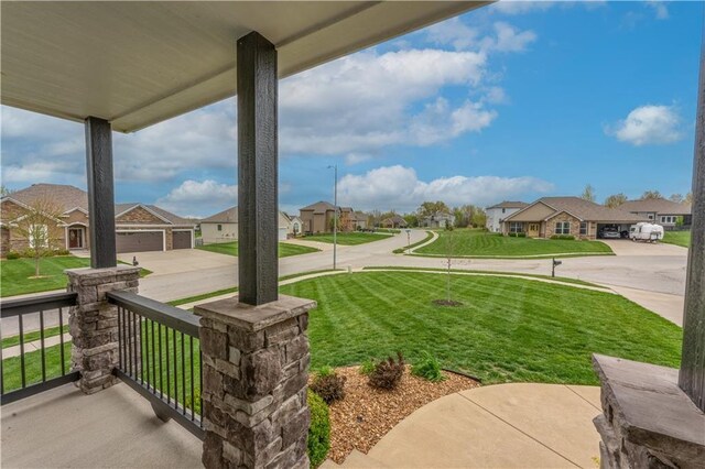 view of yard with covered porch and a residential view