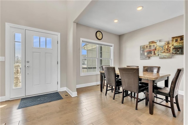 dining area with recessed lighting, baseboards, and light wood-style flooring