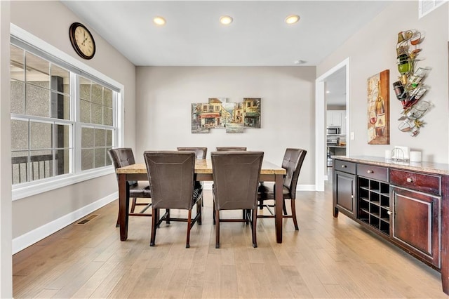 dining area featuring baseboards, light wood finished floors, recessed lighting, and visible vents