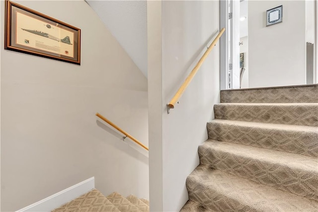 stairs featuring vaulted ceiling