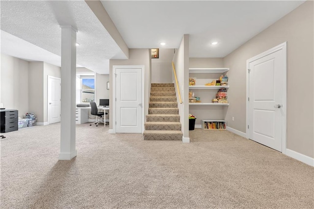 basement featuring carpet floors, recessed lighting, baseboards, and stairs