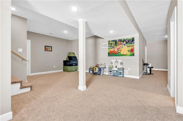 finished below grade area with carpet floors, stairs, recessed lighting, baseboards, and visible vents
