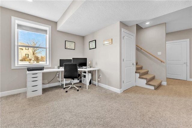 office space with baseboards, carpet flooring, and a textured ceiling