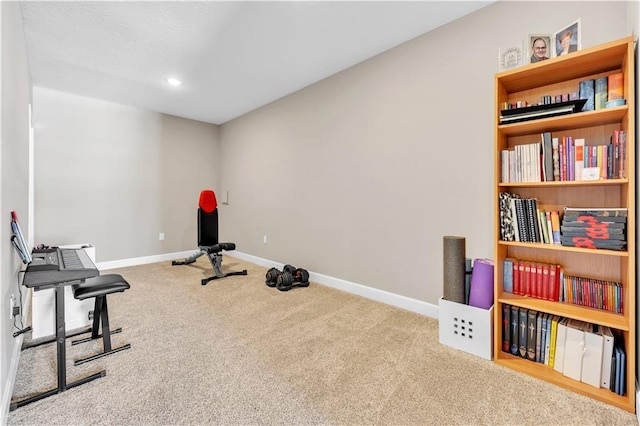 exercise room featuring carpet flooring, recessed lighting, and baseboards