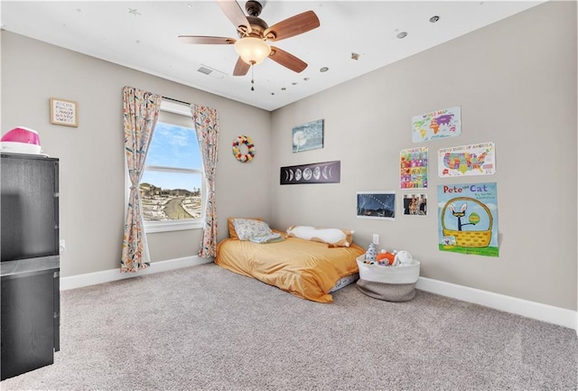 carpeted bedroom featuring baseboards and ceiling fan