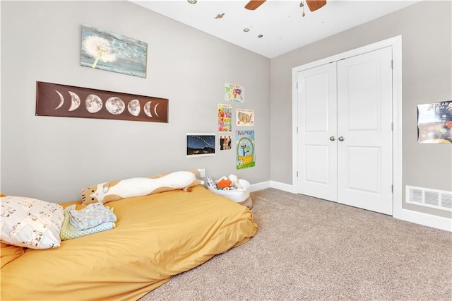 bedroom with visible vents, carpet floors, a closet, baseboards, and a ceiling fan