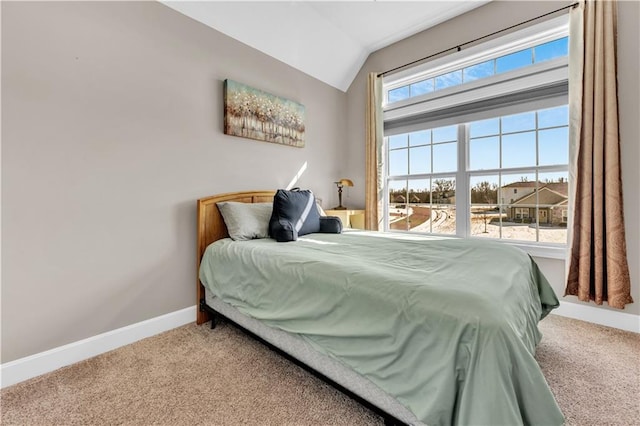 bedroom featuring baseboards, carpet, and vaulted ceiling