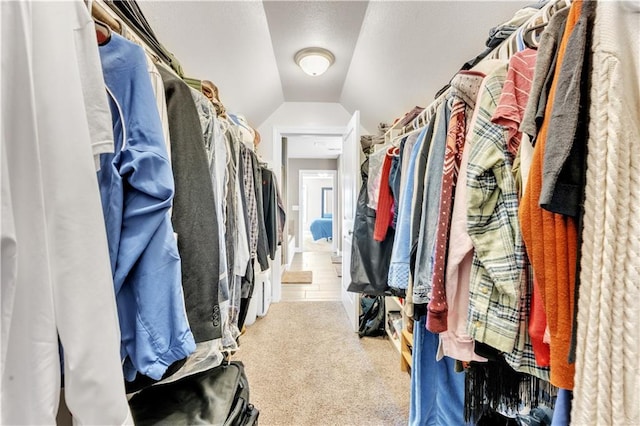 spacious closet with carpet flooring and lofted ceiling