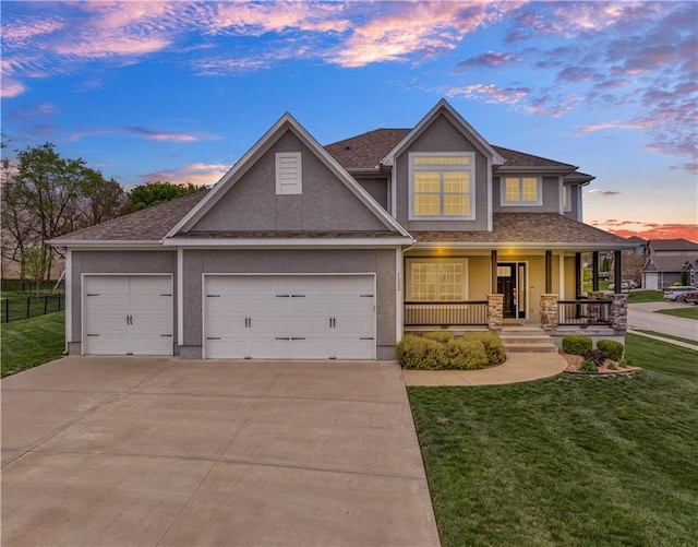 view of front of property featuring covered porch, driveway, a front lawn, an attached garage, and stucco siding