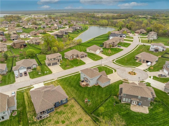 drone / aerial view featuring a residential view and a water view