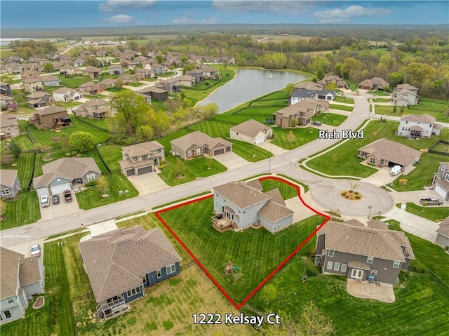 birds eye view of property featuring a water view and a residential view