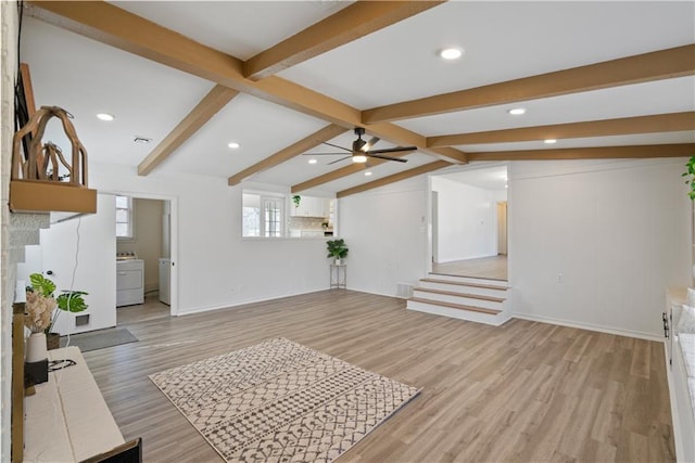 living room with light wood finished floors, washer / dryer, visible vents, a ceiling fan, and vaulted ceiling with beams