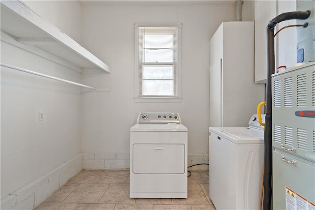 washroom featuring laundry area, light tile patterned floors, and separate washer and dryer