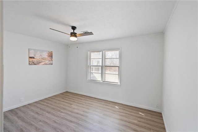 unfurnished room with light wood finished floors, a ceiling fan, and baseboards