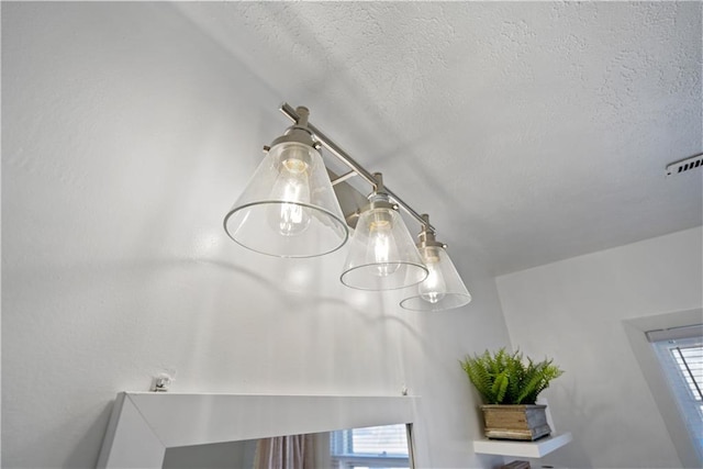 interior details featuring visible vents and a textured ceiling