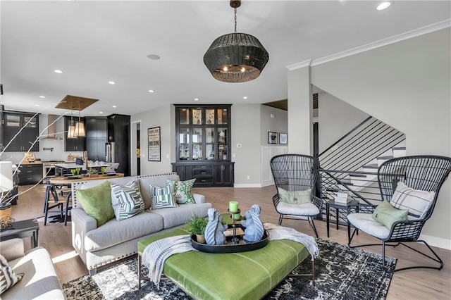 living area with stairs, recessed lighting, baseboards, and wood finished floors