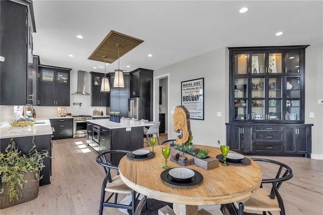 dining space featuring recessed lighting and light wood-style floors