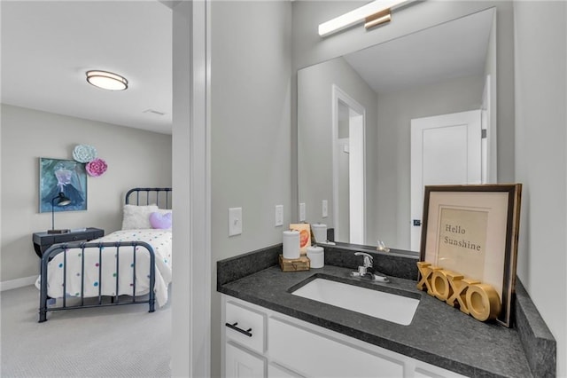 bathroom with vanity and baseboards