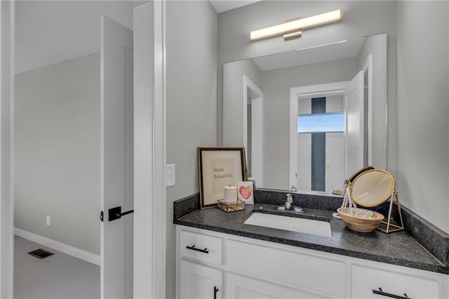 bathroom featuring baseboards, visible vents, and vanity