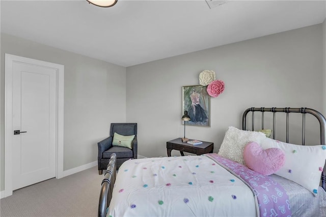 bedroom with light carpet and baseboards